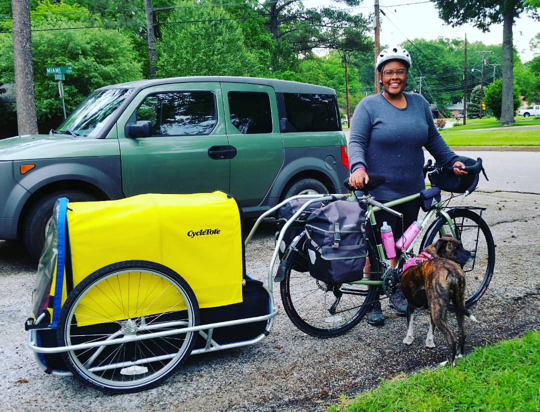 Jasmine Reese with her bicycle and dog, Fiji